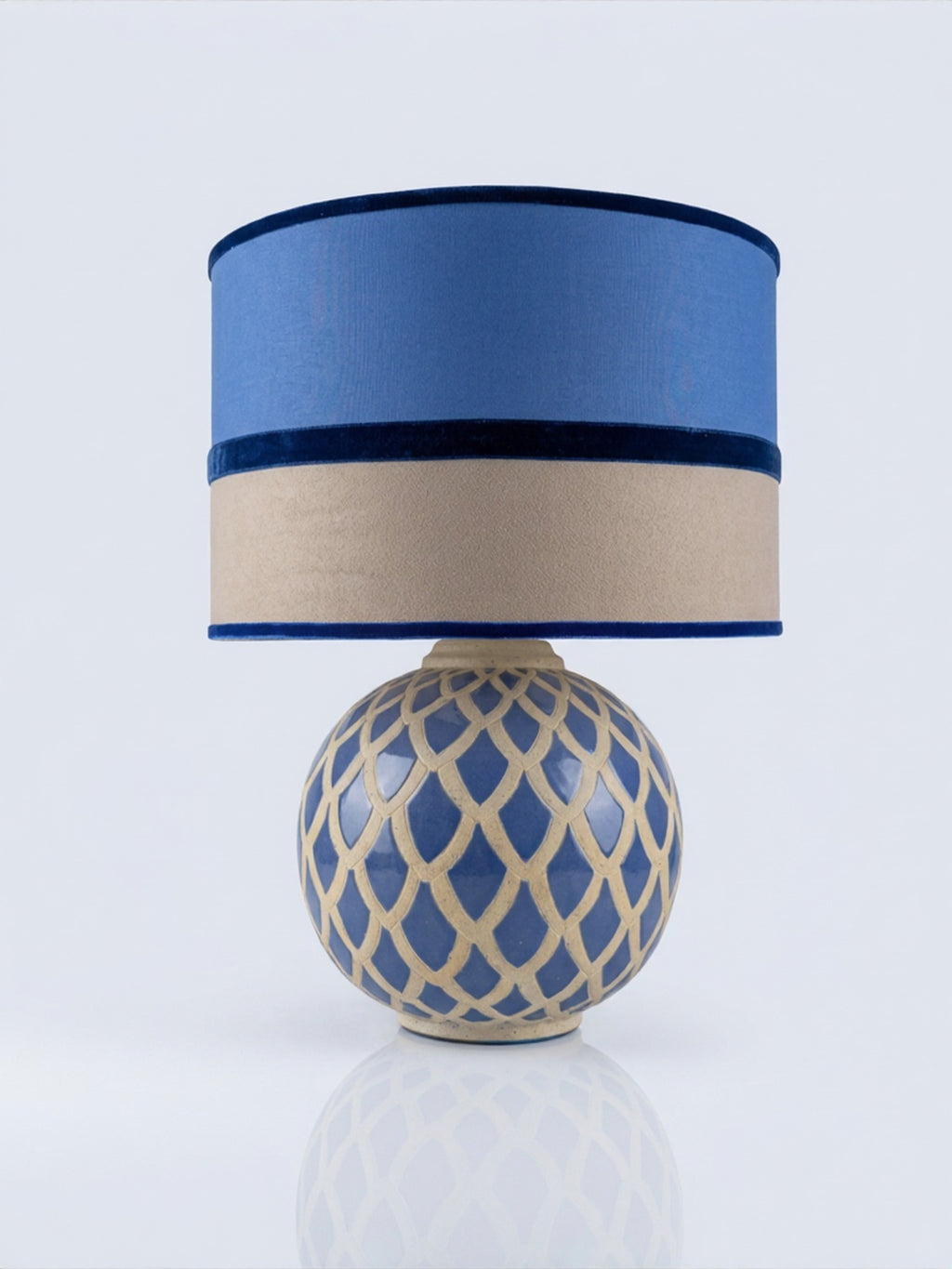 Vintage blue ceramic lamp base pictured with a blue and taupe lampshade; the lampshade is not included