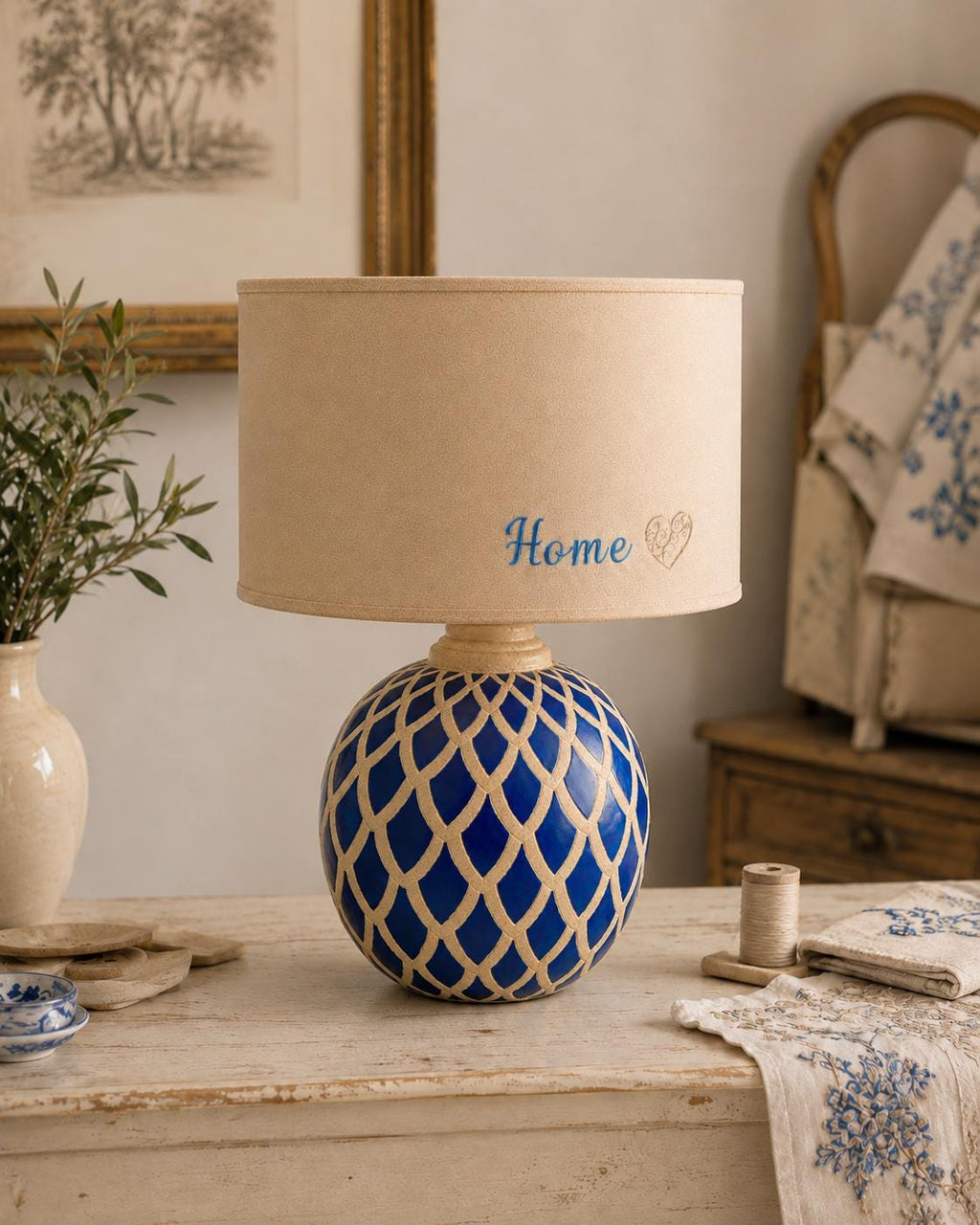 Vintage blue ceramic lamp base photographed with a lampshade for display; lampshade not included.