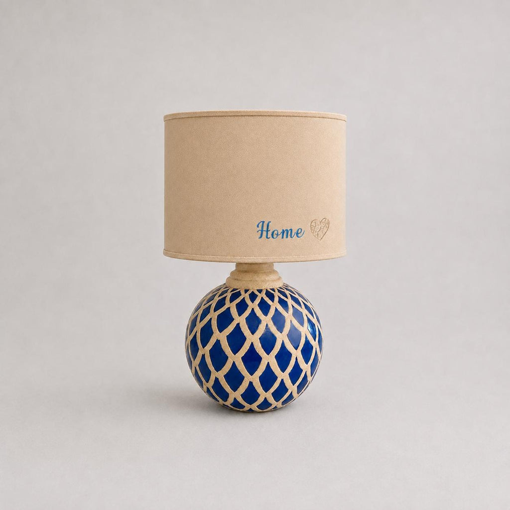 Vintage blue ceramic lamp base photographed with a lampshade for display; lampshade not included.