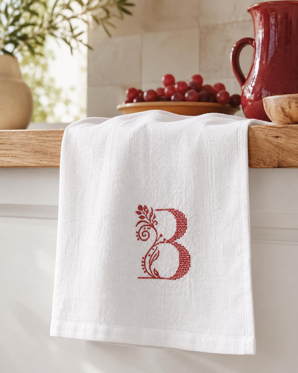 Personalised Italian linen kitchen towel with embroidered botanical monogram