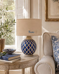 Vintage blue ceramic lamp base photographed with a lampshade for display; lampshade not included.