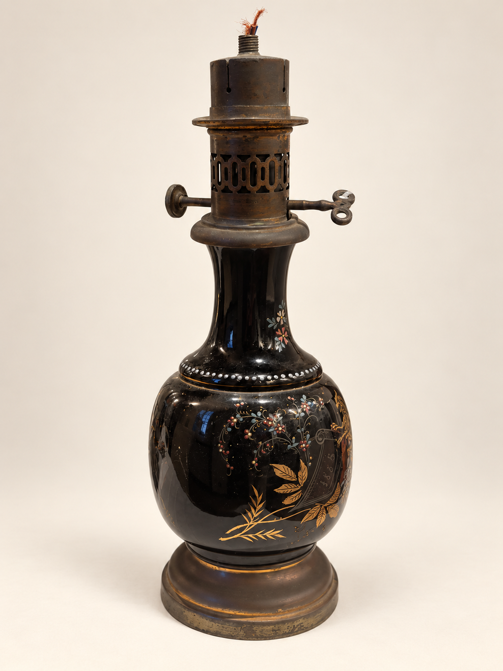 Floral vintage black-glazed ceramic oil lamp with original oil burner
