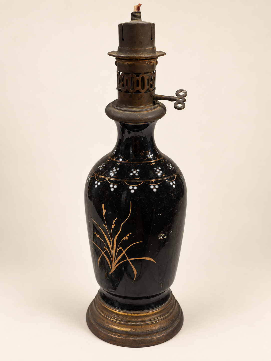Vintage black-glazed ceramic oil lamp with gilt reed decoration and original oil burner