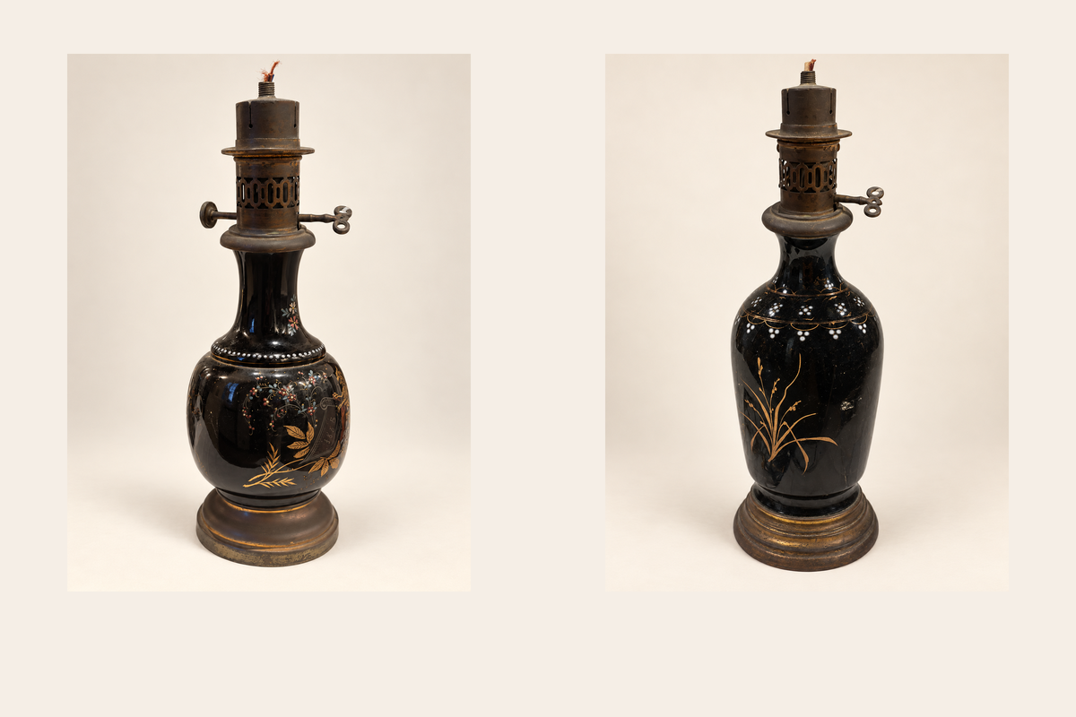 Pair of vintage black-glazed ceramic oil lamps with different decorations and original oil burners