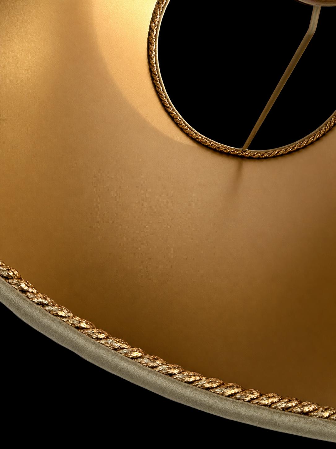 Detail of bronze passementerie and gold PVC lining on the green peacock feather lampshade